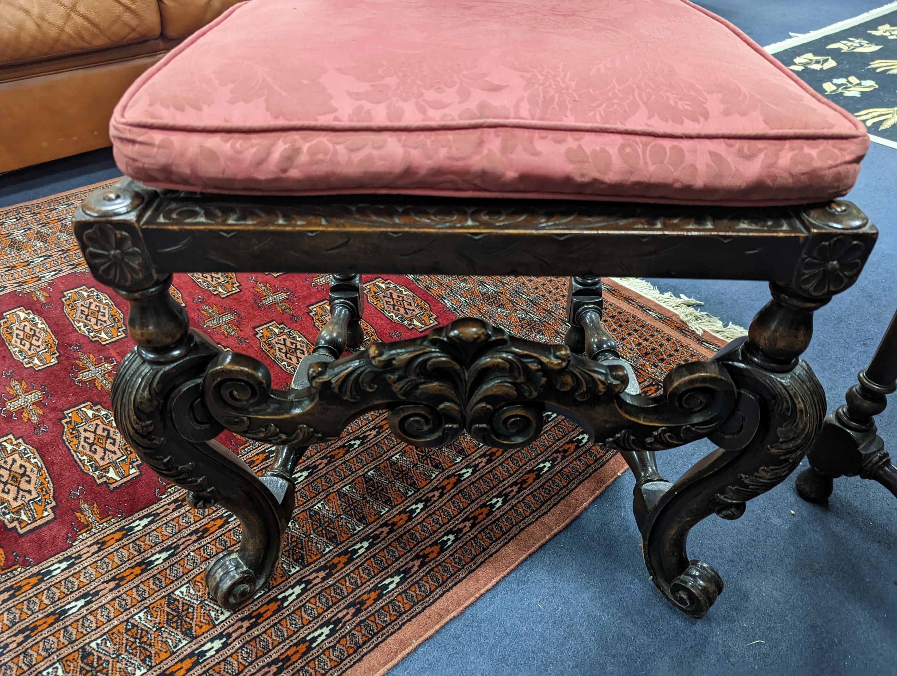 A set of six Charles II style carved oak dining room chairs with caned backs and seats and squab cushion seats